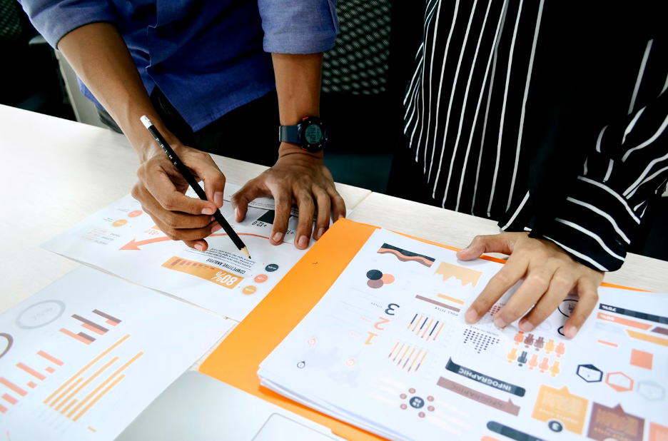 two people looking at data from a report