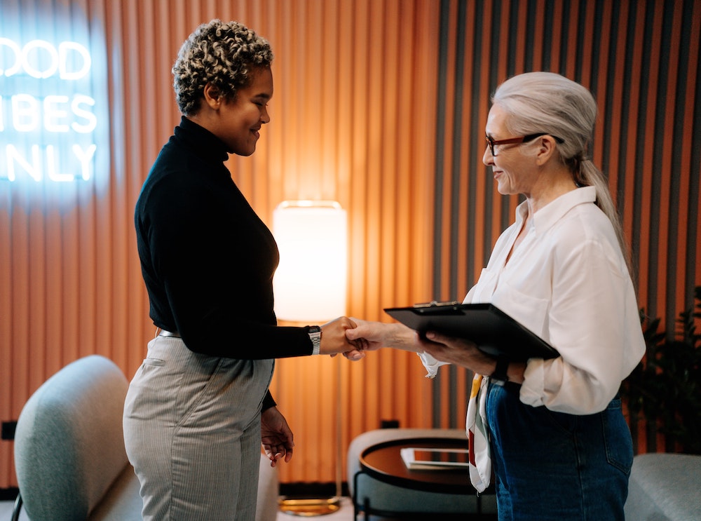 An eCommerce sellers shakes hand with someone who gave them a loan.